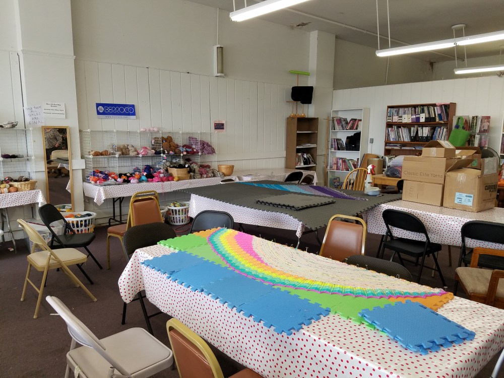 Shawls blocking in Mass Ave Knit Shop sale room