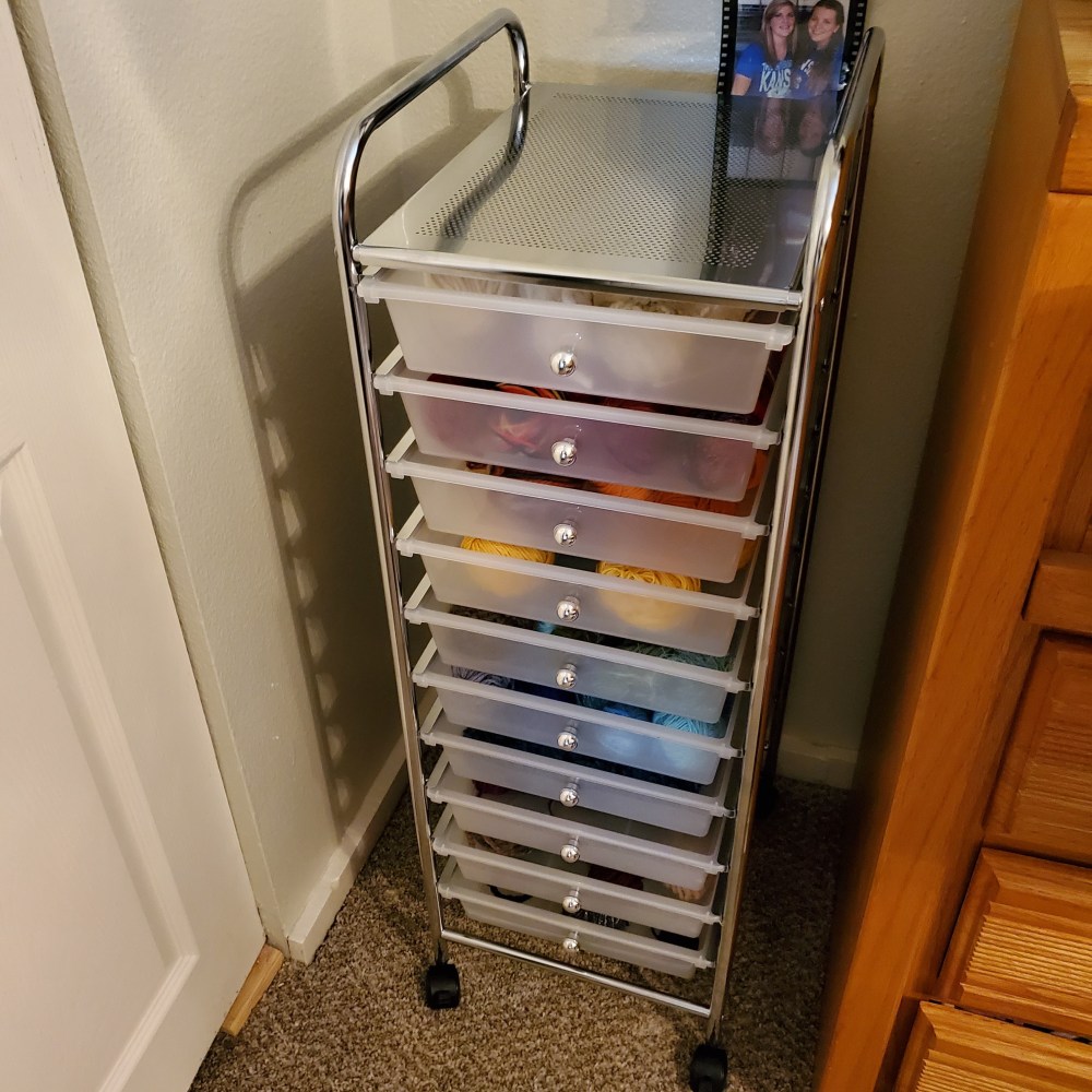 Craft cart with 11 bins holding yarn sorted by color