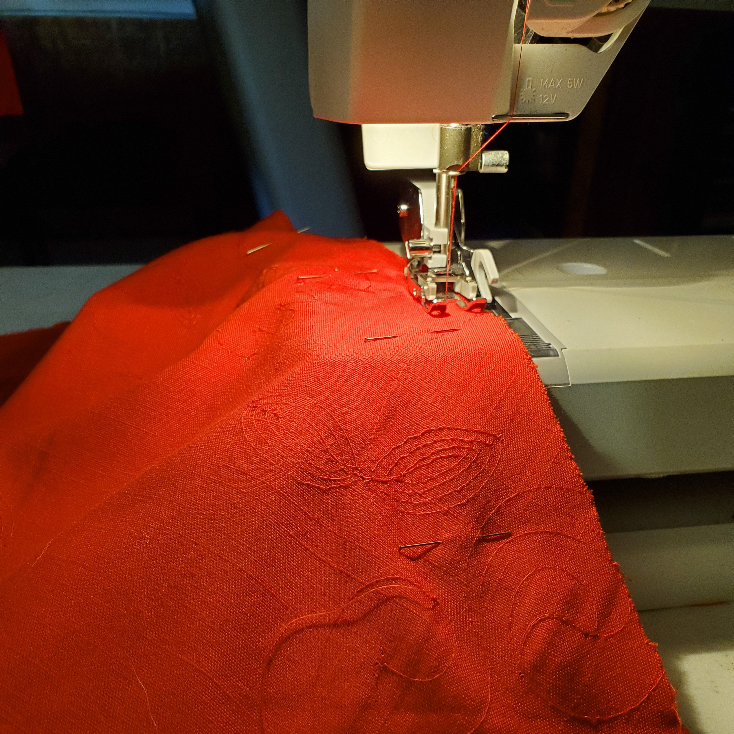linen going through sewing machine