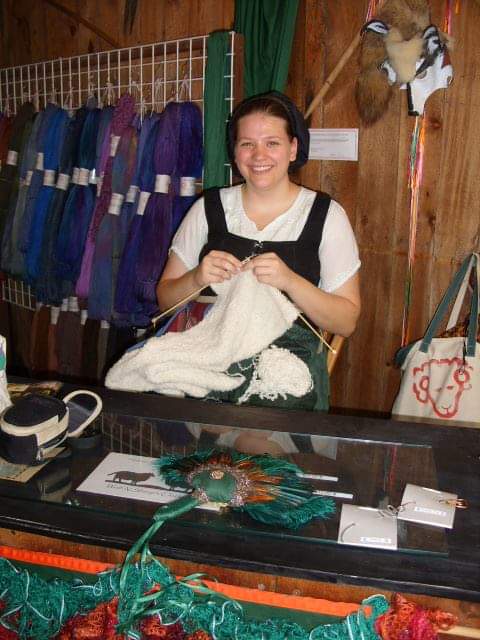 Emma knitting in the Renaissance Festival booth