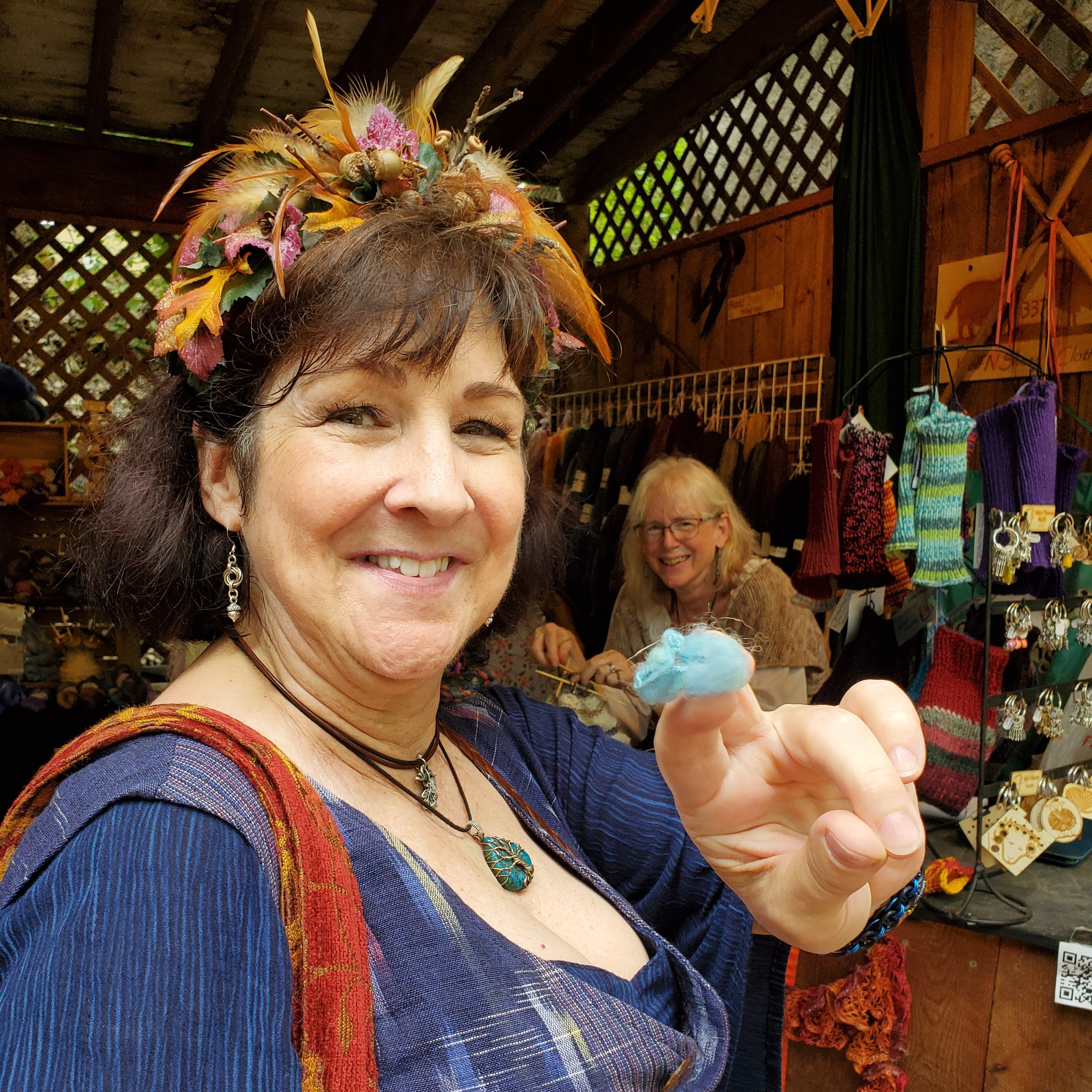 Chrissy holding up a piece of blue fiber