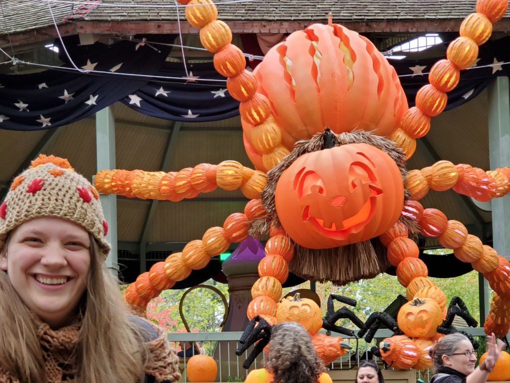 Emma in front of the giant pumpkin spider