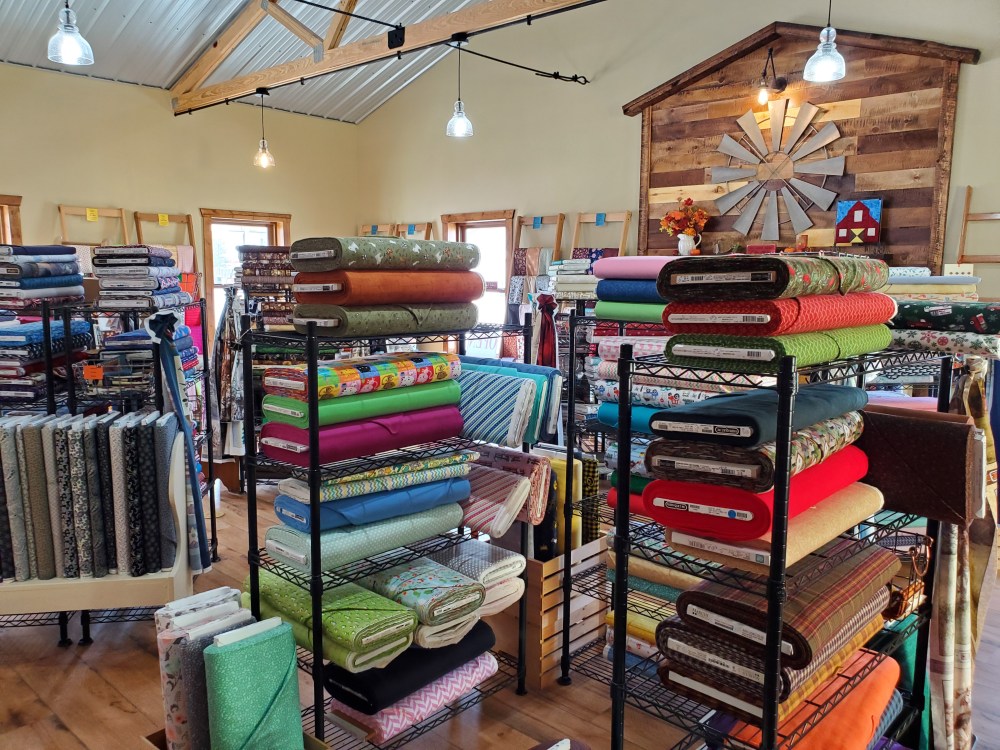 Bolts of fabric in the Snips of Thread quilt shop