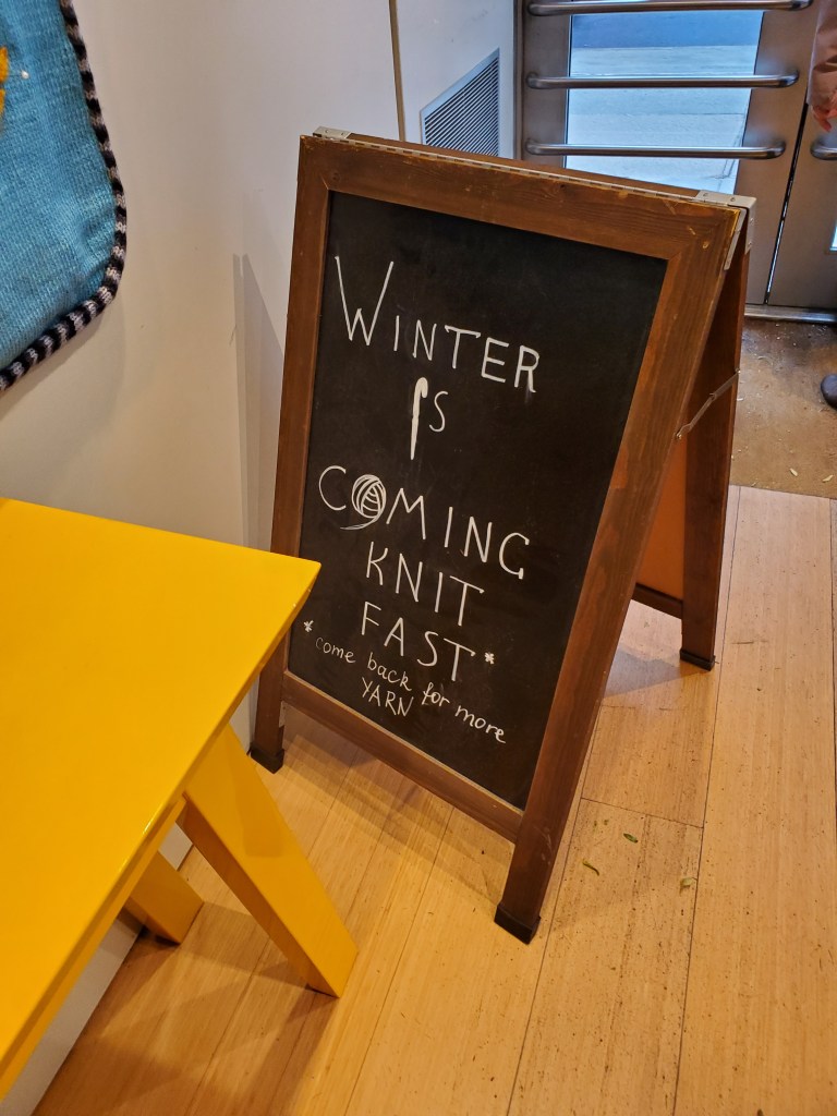Sign that says "Winter is Coming. Knit Fast. Come back for more YARN."