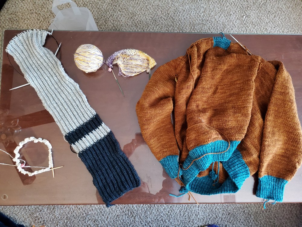 In-progress projects: crop top, ribbed scarf, cowldana, and sweater.