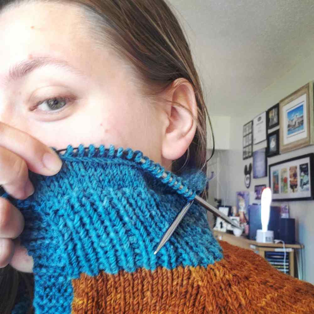 Emma showing off the partial hood on her sweater