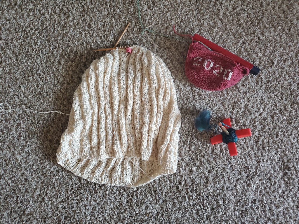 In-progress crop top, Little House, and spinning project