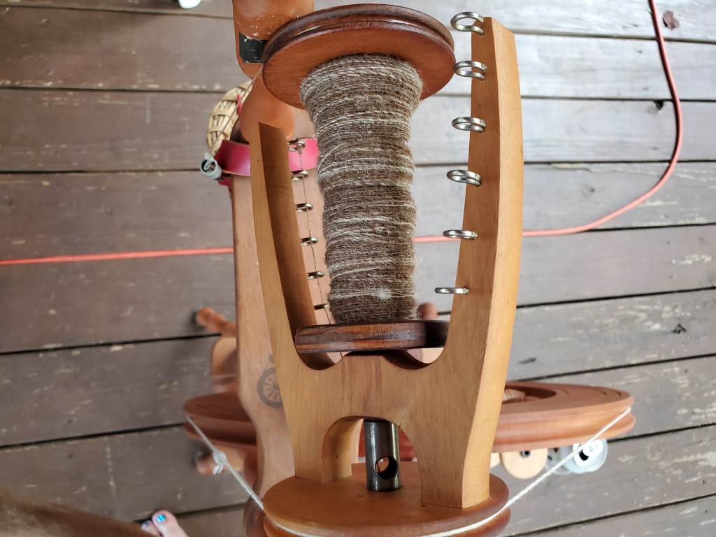 Half-full bobbin of a thin, brown single