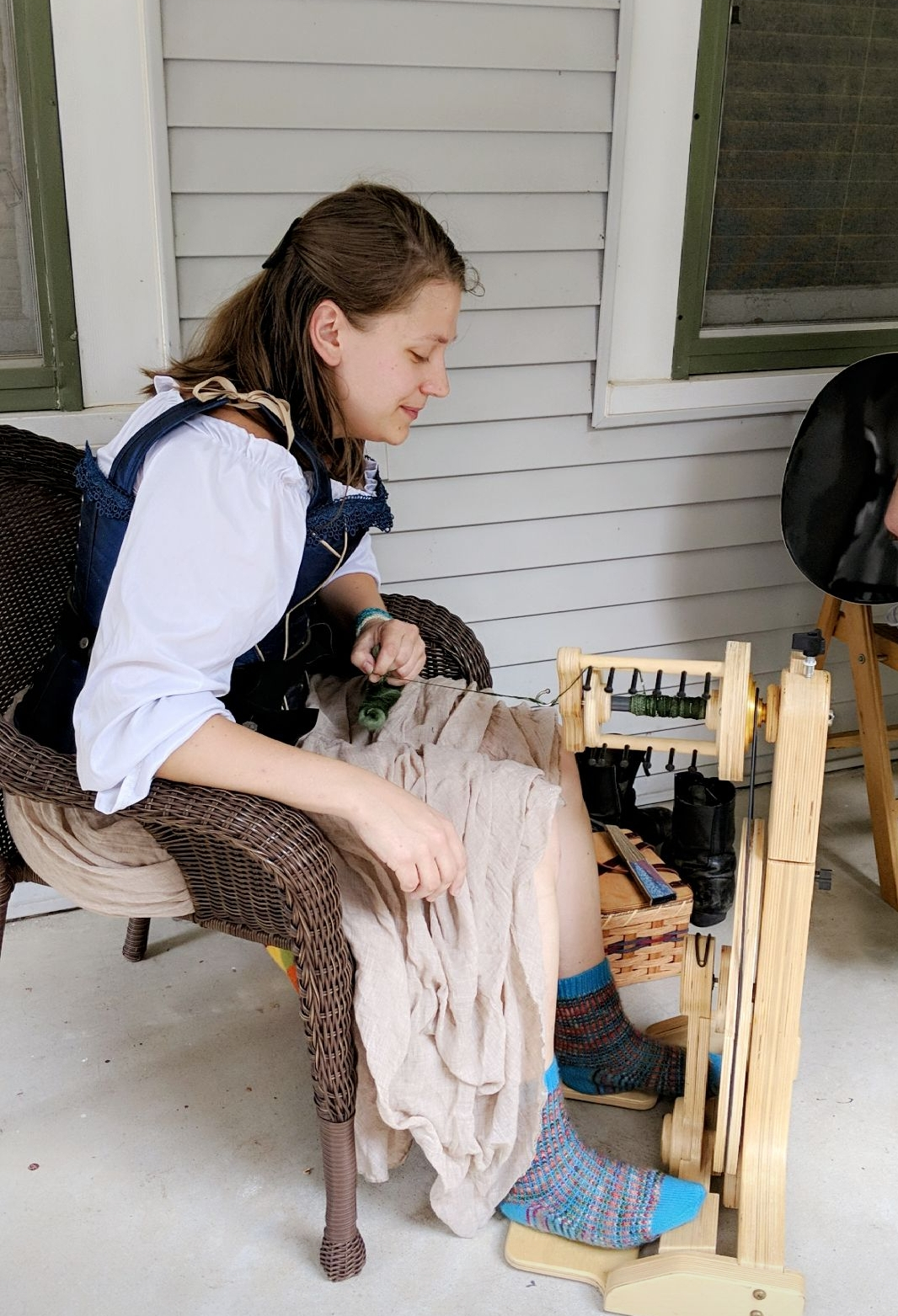Emma spinning on a wheel