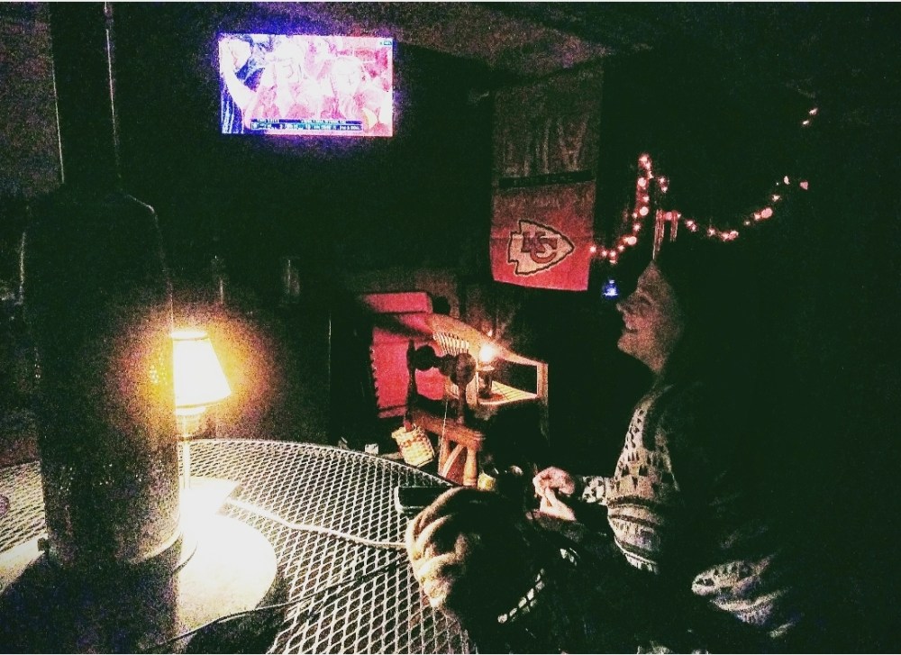 Emma spinning on a deck in front of a tv with a football game on