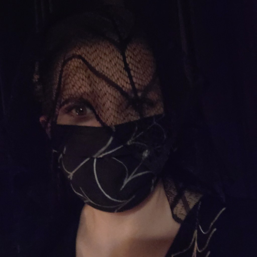 Emma in a viel and spiderweb mask