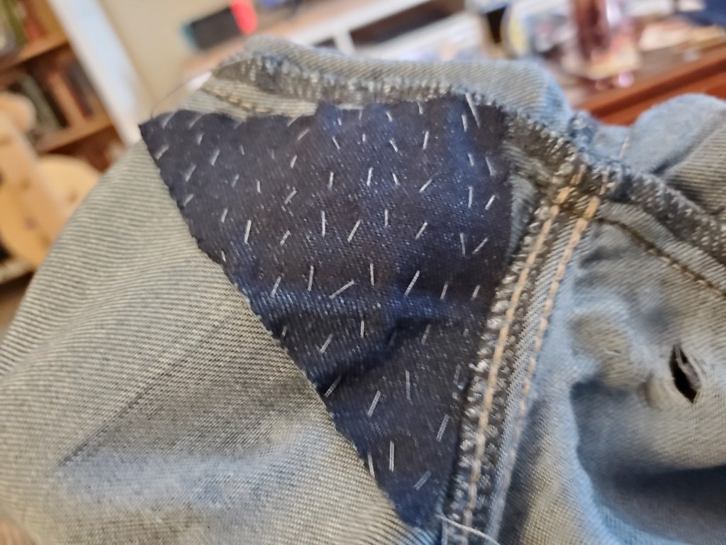 Patch with rows of vertical running stitch