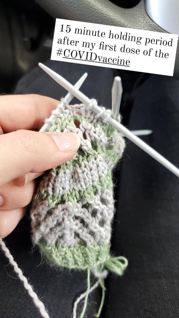 knitting project, with text that reads "15 minute holding period after my first dose of the COVID vaccine