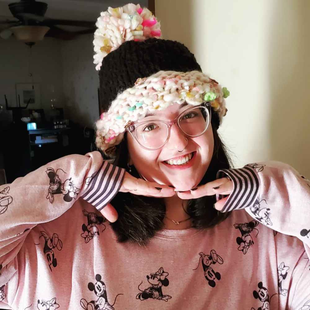 Addie wearing her hat made from the yarn she picked from Nina Chicago