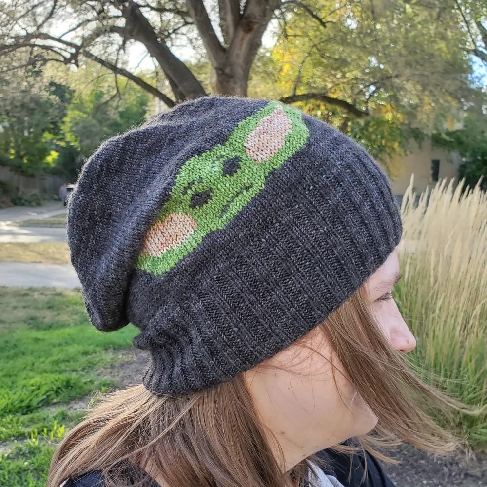 Emma modeling the Baby Yoda hat