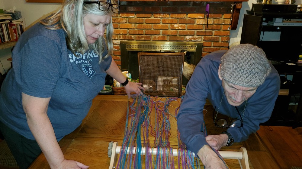 Emma's Mom and Dad detangling warp threads
