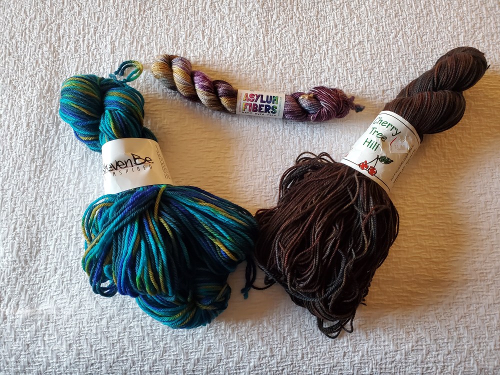 Two full skeins and one mini skein of yarn