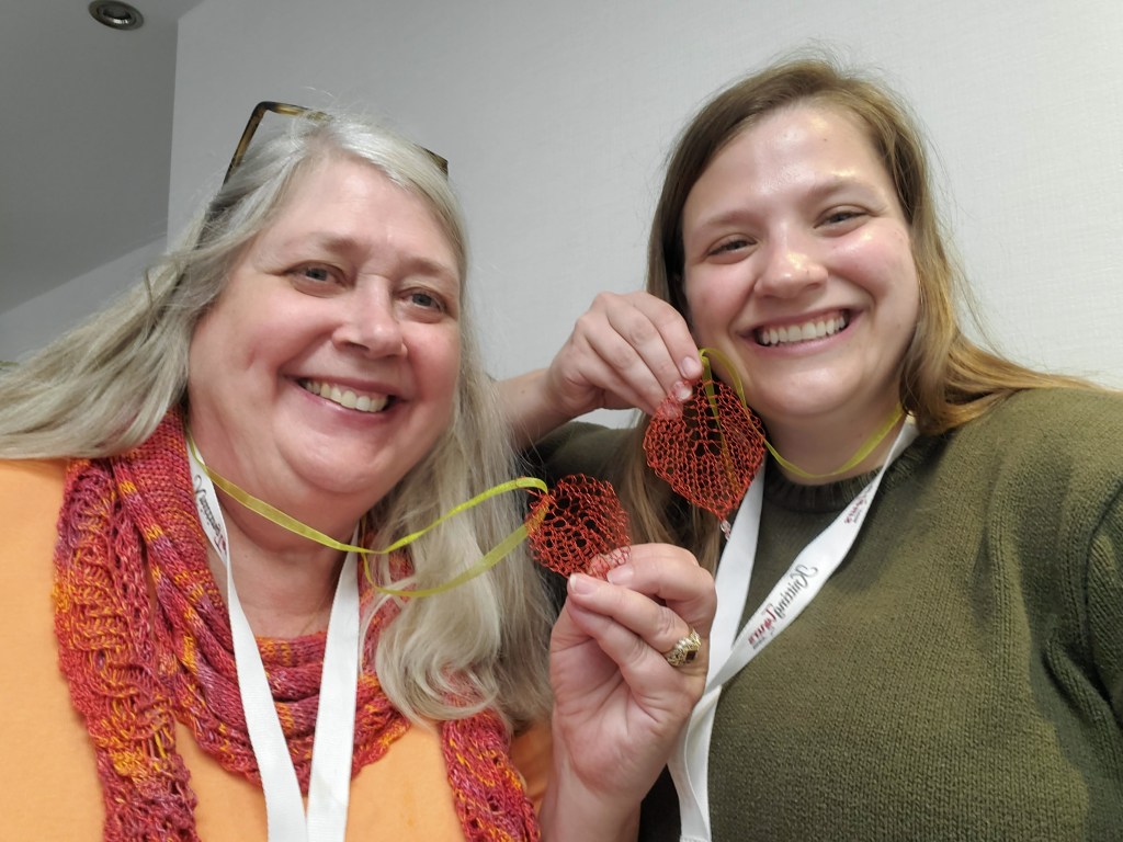 Cyndi and Emma modeling their knit wire leaves